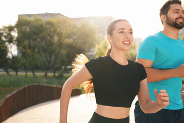 Sticker - Healthy lifestyle. Happy couple running outdoors on sunny day