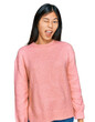 © Krakenimages.com - Beautiful young asian woman wearing casual winter sweater winking looking at the camera with sexy expression, cheerful and happy face.