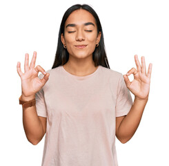 Sticker - Young asian woman wearing casual clothes relax and smiling with eyes closed doing meditation gesture with fingers. yoga concept.