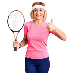 Sticker - Young blonde woman playing tennis holding racket smiling happy and positive, thumb up doing excellent and approval sign