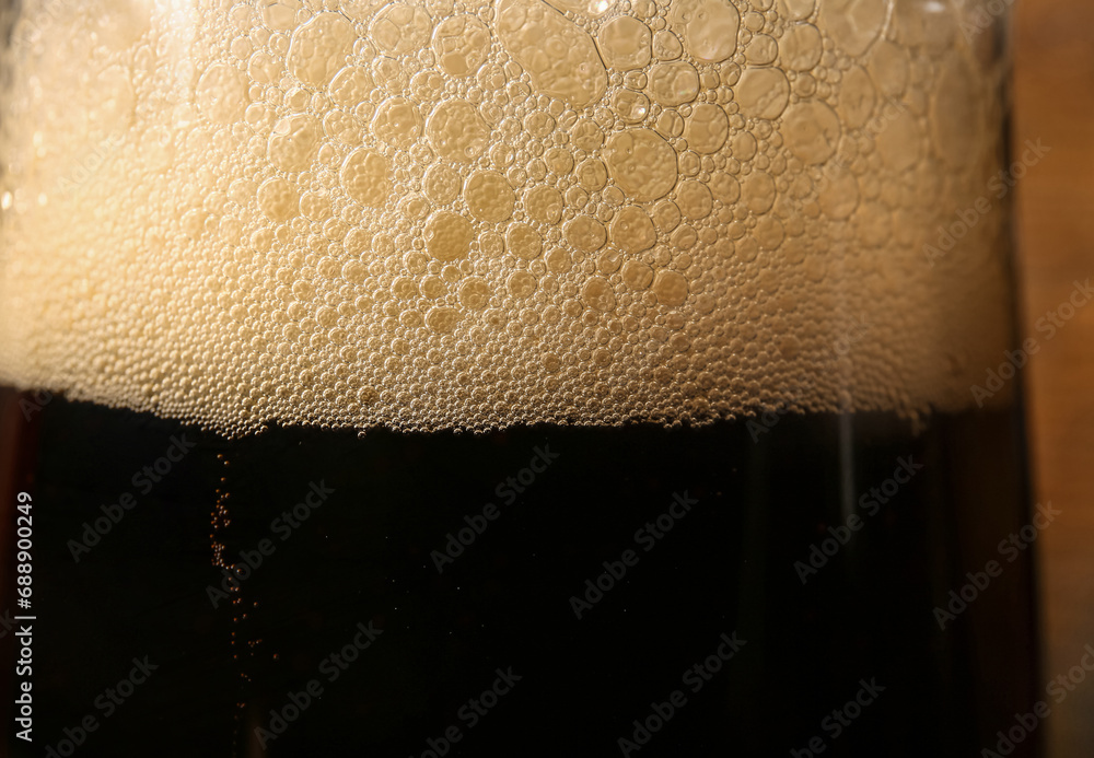 Glass of cold dark beer as background