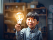 電球を持つアジア人の笑顔の男の子。勉強や電気のイメージ。生成AI