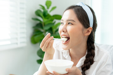 healthy food. Beautiful female girl enjoy eat yogurt, granola, fresh fruits on breakfast health in house. Happy young woman smile on morning good emotion. dieting, detox, diet, clean eat, vegetarian