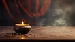 A lit candle and incense stick emitting smoke on a wooden surface