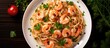 Top view of shrimp linguine pasta with parsley on a plate, taken from above.
