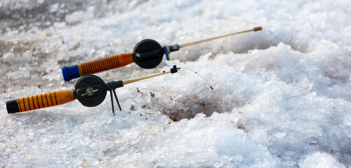 Sticker - Fishing rod on ice in winter. Ice fishing