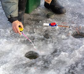 Sticker - A man catches fish on the ice with a fishing rod