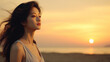 Portrait of a young South Korean woman looking up at the sky, against the backdrop of sunset on the asian beach, showing nostalgia and some kind of sadness in her expression , copy space