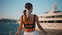 Tanned Woman Posing Pier With Luxury Yacht Close Up. Girl Standing On Embankment