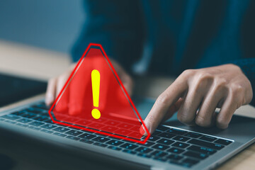 Wall Mural - laptop shows a warning sign of system failure. concept notification a spam, risk of website technolo