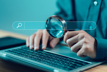 Wall Mural - businessman using a laptop, show search bar. concept of a website to find a job and career on the in