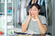 © DG PhotoStock - Stressful Asian young woman fasion designer taking a rest after working for many hours.