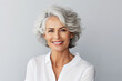 © Ishra - Matured woman with wrinkles in her face isolated on gray background. beautiful smiling woman with good health. Short hair modern 50s mid-aged woman portrait, Old lady Skin care advertising concept