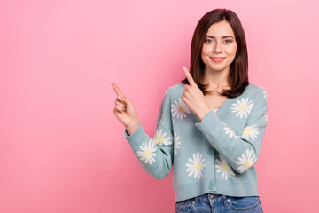 Wall Mural - Photo of cute shop assistant lady direct fingers empty space sale banner wear cardigan jeans isolated pink color background