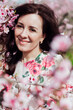 © dmitriisimakov - travel walk beautiful brunette woman in flowering trees spring nature