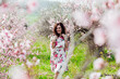 © dmitriisimakov - spring nature travel walk beautiful woman brunette in flowering trees