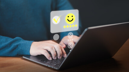Fototapete - User use a laptop give point with virtual screen on smile face icon for satisfaction in opinion and service. Customer satisfaction survey, service rating online, testimonial feedback review.