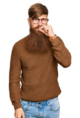 Wall Mural - Young irish redhead man wearing casual clothes and glasses mouth and lips shut as zip with fingers. secret and silent, taboo talking