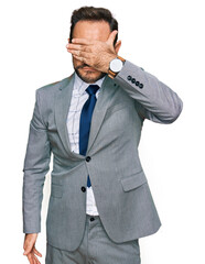 Sticker - Middle age man wearing business clothes covering eyes with hand, looking serious and sad. sightless, hiding and rejection concept