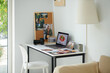 © DragonImages - Printed photos on desk of photographer in his home office