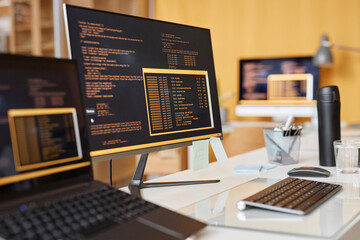 close up background image of computer screen with colored code lines at workplace in it development 