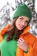 © forma82 - Beautiful brunette in green hat in snowy forest.
