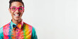 Joyful young Asian-American man in colorful shirt and pink glasses, exuding charisma and playfulness on a white background.