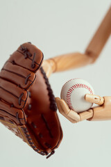 Wall Mural - Wooden hands holding a baseball glove and a ball. Bright photo on a white background.