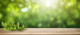 Nature themed background with a wooden table in a garden featuring bokeh in a spring summer setting The wood surface is versatile serving as a shelf counter desk and for picnic meals and produc