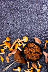 Wall Mural - Frying pan with fried mushrooms on dark background