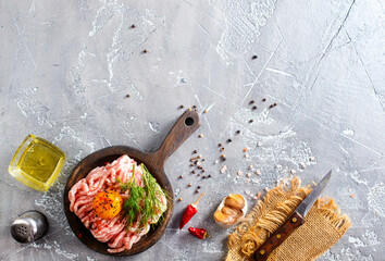 Canvas Print - Raw minced meat with olive oil, yolk, and garlic.