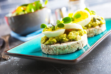 Canvas Print - Healthy tasty toast with avocado, white cheese and boiled egg on plate