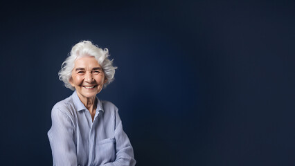 Wall Mural - Beautiful old woman smiling isolated on studio background. Copyspace area