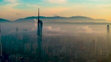 An Establish Aerial Hyperlapse Shot Of Kuala Lumpur City Overseeing The Main Four Towers Skyscrappers During Misty Morning
