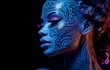 Woman's portrait under UV light wearing neon makeup with an ethnic motif. Posing in UV, the body art design features a painted face and hand, as well as vivid makeup..