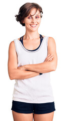 Poster - Beautiful young woman with short hair wearing casual sport clothes happy face smiling with crossed arms looking at the camera. positive person.