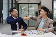 © ArLawKa - Businessman and corporate lawyer successfully shake hands in law office Lawyers and clients receive legal advice and celebrate victories.