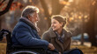 © Studio Nova - Senior man in wheelchair with his daughter in autumn park