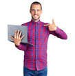 © Krakenimages.com - Young handsome man working using computer laptop pointing finger to one self smiling happy and proud
