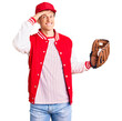 © Krakenimages.com - Young handsome man wearing baseball uniform holding golve and ball stressed and frustrated with hand on head, surprised and angry face