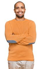 Wall Mural - Hispanic adult man wearing casual winter sweater happy face smiling with crossed arms looking at the camera. positive person.