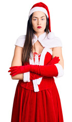 Canvas Print - Young beautiful caucasian woman wearing santa claus costume skeptic and nervous, disapproving expression on face with crossed arms. negative person.