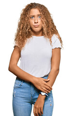 Poster - Beautiful caucasian teenager girl wearing casual white tshirt looking sleepy and tired, exhausted for fatigue and hangover, lazy eyes in the morning.