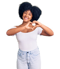 Wall Mural - Young african american girl wearing casual clothes smiling in love showing heart symbol and shape with hands. romantic concept.