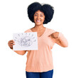 © Krakenimages.com - Young african american girl holding scribble draw pointing finger to one self smiling happy and proud