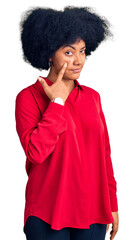 Wall Mural - Young african american girl wearing casual clothes pointing to the eye watching you gesture, suspicious expression