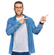 © Krakenimages.com - Young caucasian man wearing casual clothes pointing aside worried and nervous with both hands, concerned and surprised expression