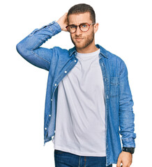 Wall Mural - Young caucasian man wearing casual clothes confuse and wondering about question. uncertain with doubt, thinking with hand on head. pensive concept.