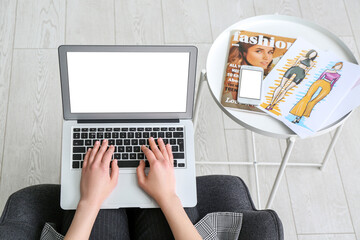 Sticker - Female designer with laptop sitting on armchair