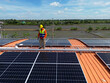 © ultramansk - engineer man inspects construction of solar cell panel or photovoltaic cell at roof top. Industrial Renewable energy of green power. factory at urban area. worker working on tower roof.